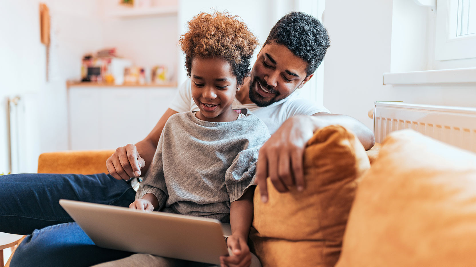 father-and-child-looking-at-laptop