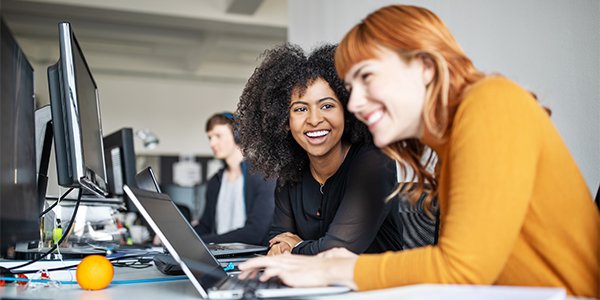 women-smiling-at-computer-600x300