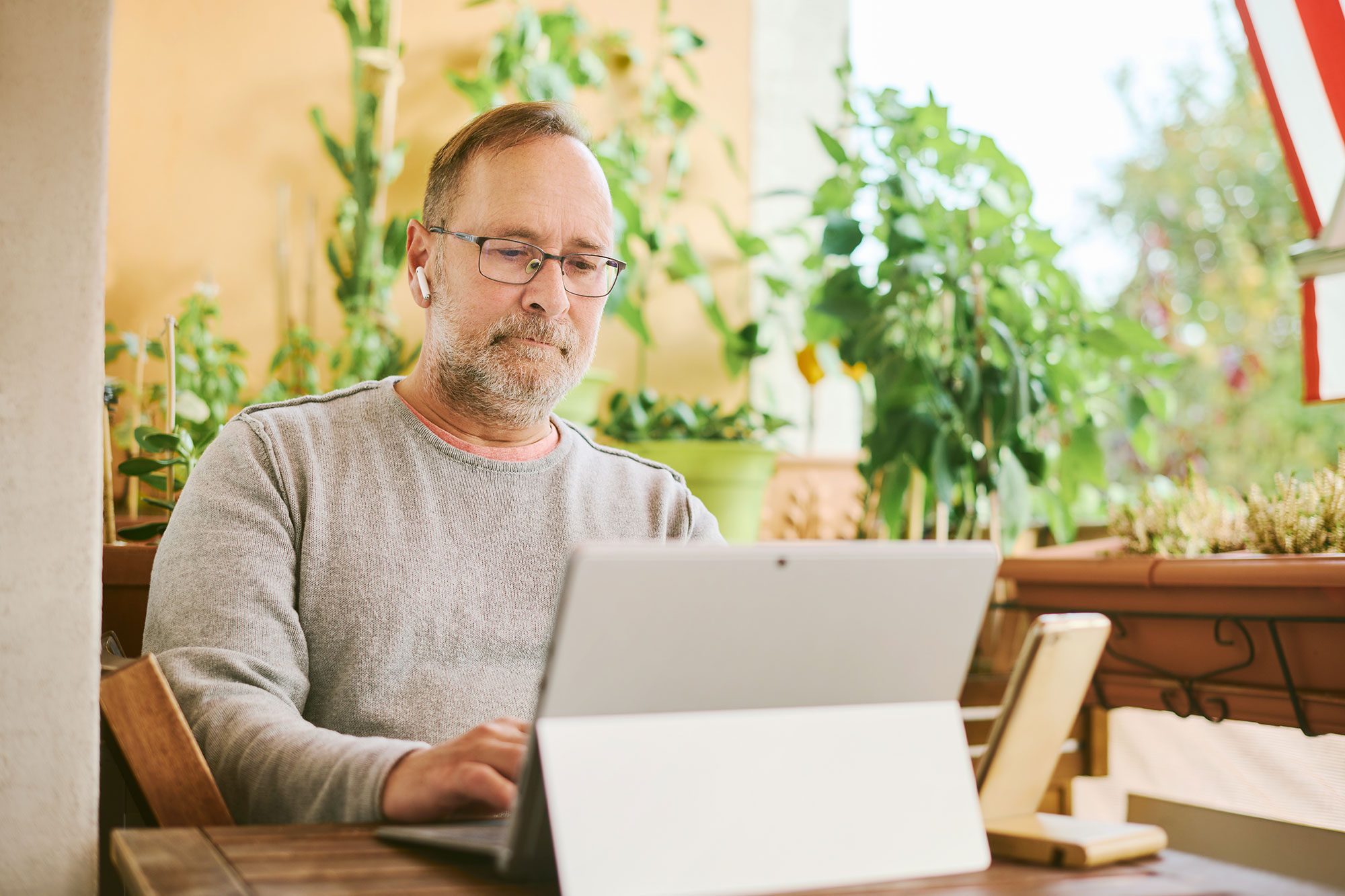 Man in mid 50s looking at a tablet