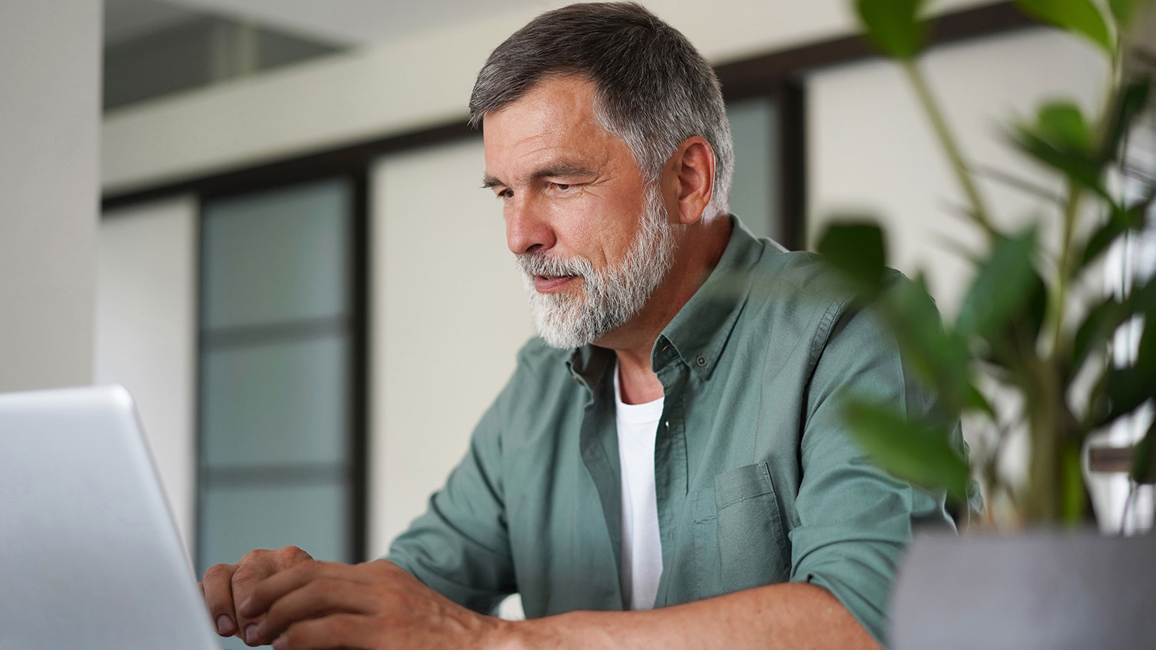 Older man on a computer in the office