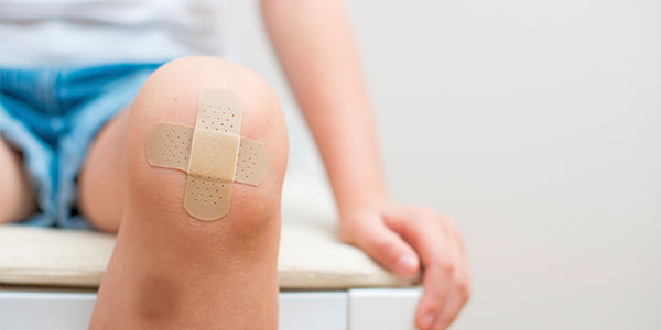 Child with bandaged knee