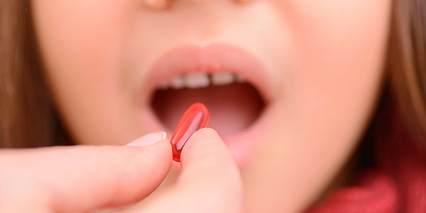 Girl taking pill