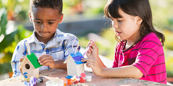 Children painting bird houses