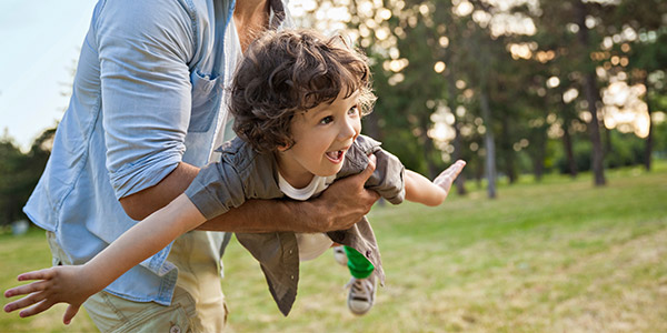 Father and young son playing outside