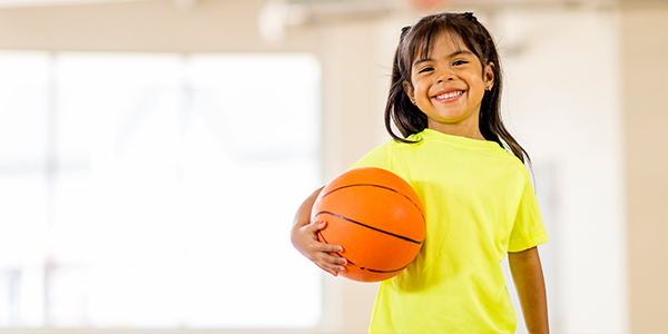 Hispanic girl playing basketball