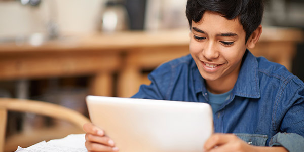 Teen boy using tablet