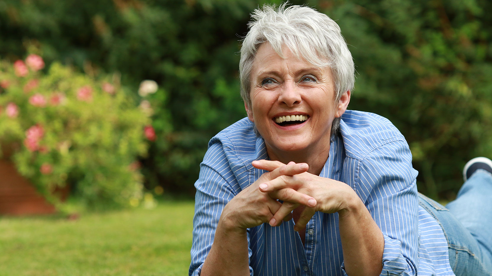 Woman smiling laying on grass