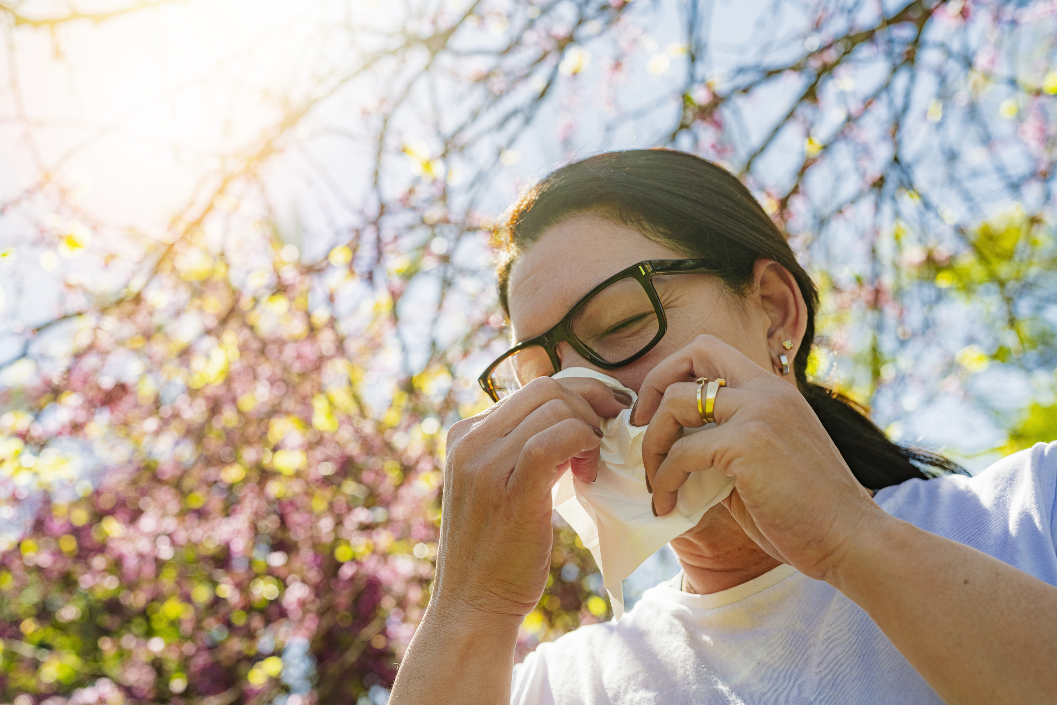 woman-sneezing-outside