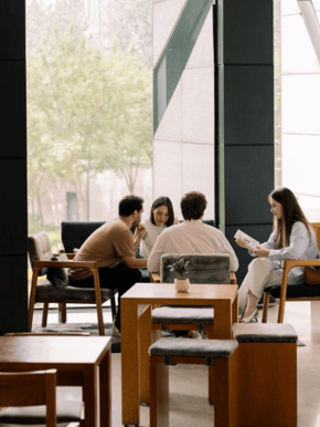 A group of people sit down at Domain for coffee