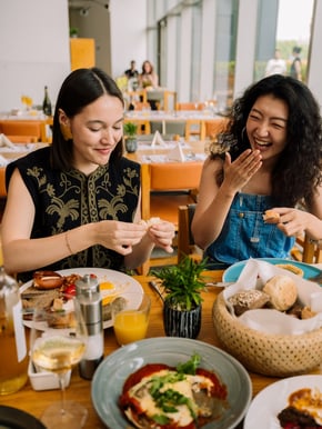 Two girls savor the food at FEAST (Food by EAST)