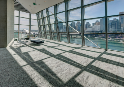 An interior photo of the International Convention Centre, ICC Sydney, looking out over the Sydney Harbour