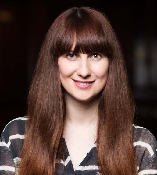 Daisy Smith, seen from the shoulders up, facing forward. She has long brown hair and is smiling.