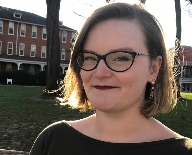 Megan McCranie, seen from the shoulders up, outdoors, looking forward and smiling slightly.