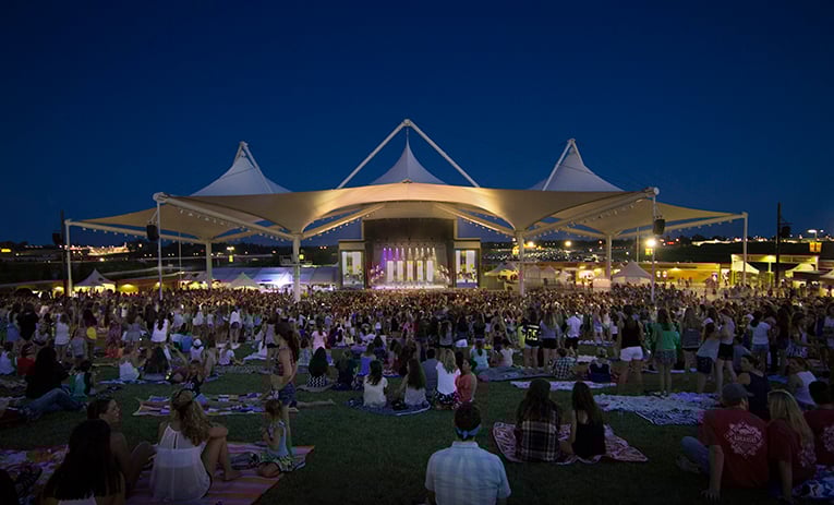 Families enjoy lawn seating at the Walmart AMP in Rogers, Ark.