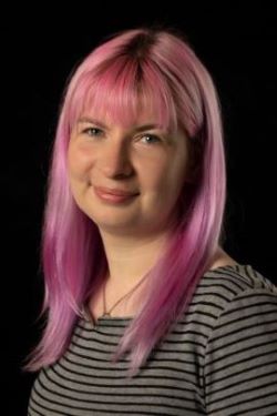 Shiona Walker wearing a striped shirt with pink hair.