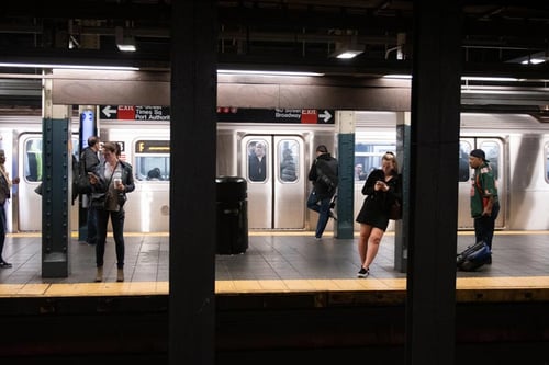 Passengers waiting on subway platform.