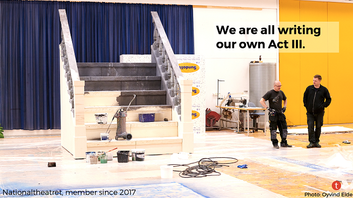 Two men standing backstage near a half-painted set of stairs. At the top, the text: We are all writing our own Act III.