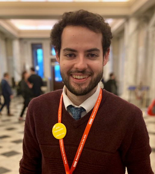 Sean Byrne, seen from the torso up standing in a hallway, facing forward and smiling.