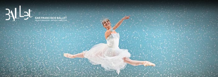 Screenshot showing a ballet dancer in white leaping in front of a light blue background with snowflakes falling