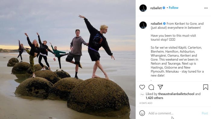 Screenshot of an Instagram post by @nzballet. The photo shows six dancers posing on dome-shaped rocks on a calm beach. The caption begins: 'From Kerikeri to Gore, and (just about) everywhere in between? Have you been to this must-visit tourist stop?'