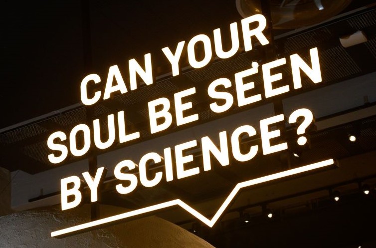 Neon sign with the words 'Can your soul be seen by science? at We The Curious.