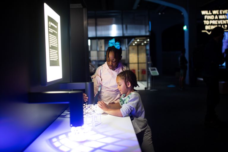 Two children interacting with an exhibit at We The Curious.