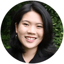 Monica Chen, seen from the shoulders, facing forward and smiling. Greenery behind her.