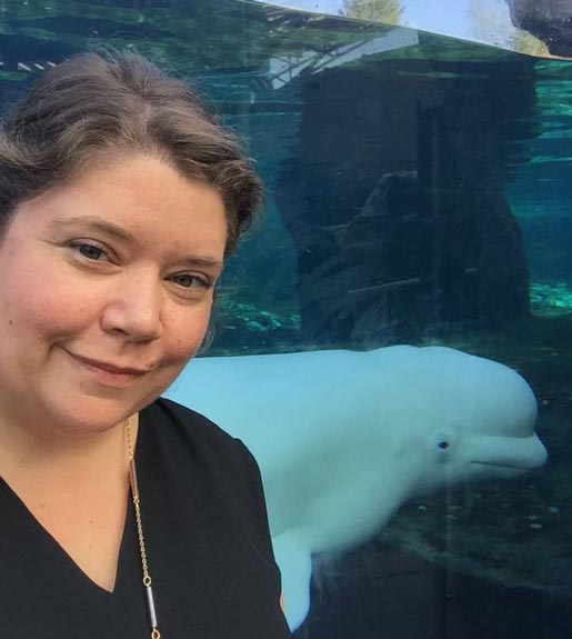 Melanie Evans, with a beluga visible in the background