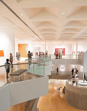 Visitors move through an airy, multistory museum space