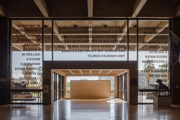 A wood-and-glass entryway seen from inside the building looking out