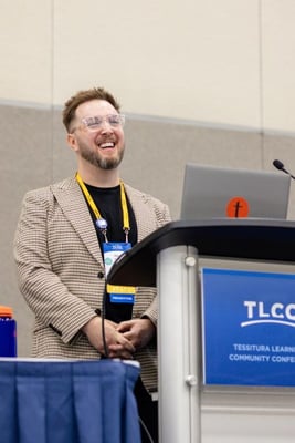 Ryan Griffin stands at a podium and presents at the Tessitura Learning and Community Conference. 