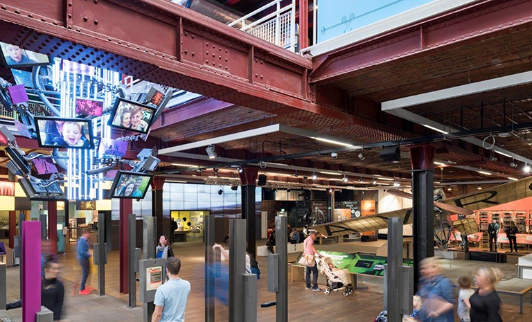 Visitors pass through a large, open lobby area at the UK's Science and Industry Museum.