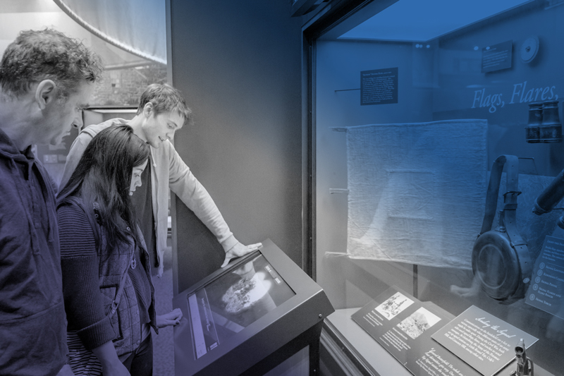 An image of two people looking at a placard at the Gettysburg Foundation. The image has a blue and gray overlay. 
