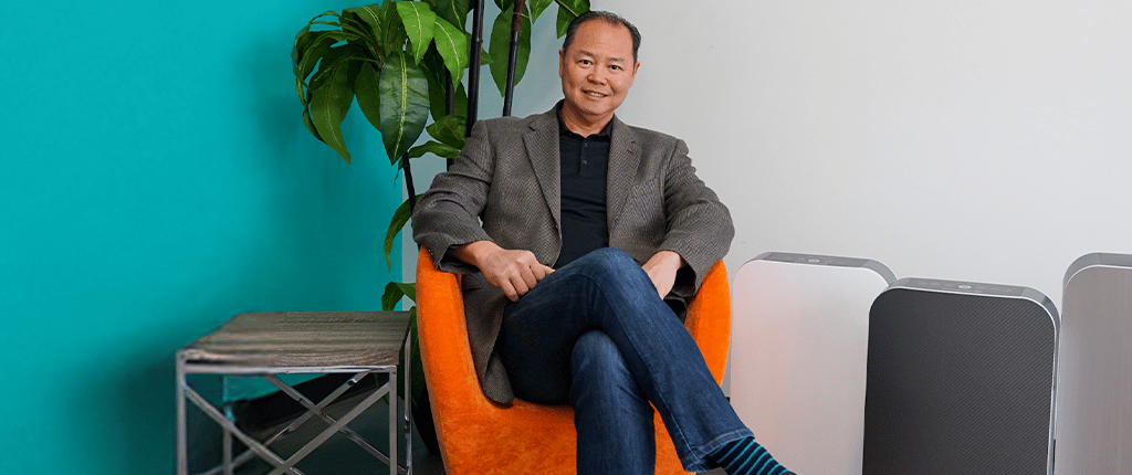 Warb Lee sitting on an orange chair