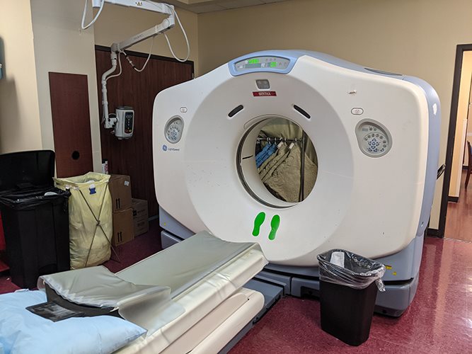 Elekta linear accelerator in a clinical treatment vault with patient couch positioned for therapy delivery