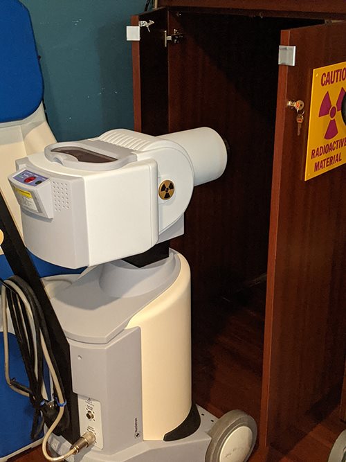 Elekta Infinity linear accelerator treatment system with dual control monitors and patient immobilization devices in a clinical radiation oncology suite