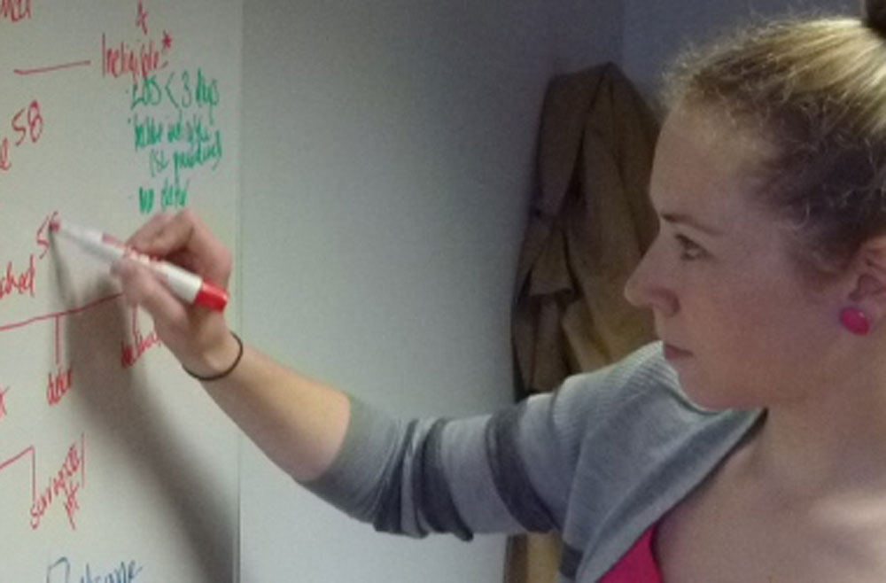 Student writing on whiteboard