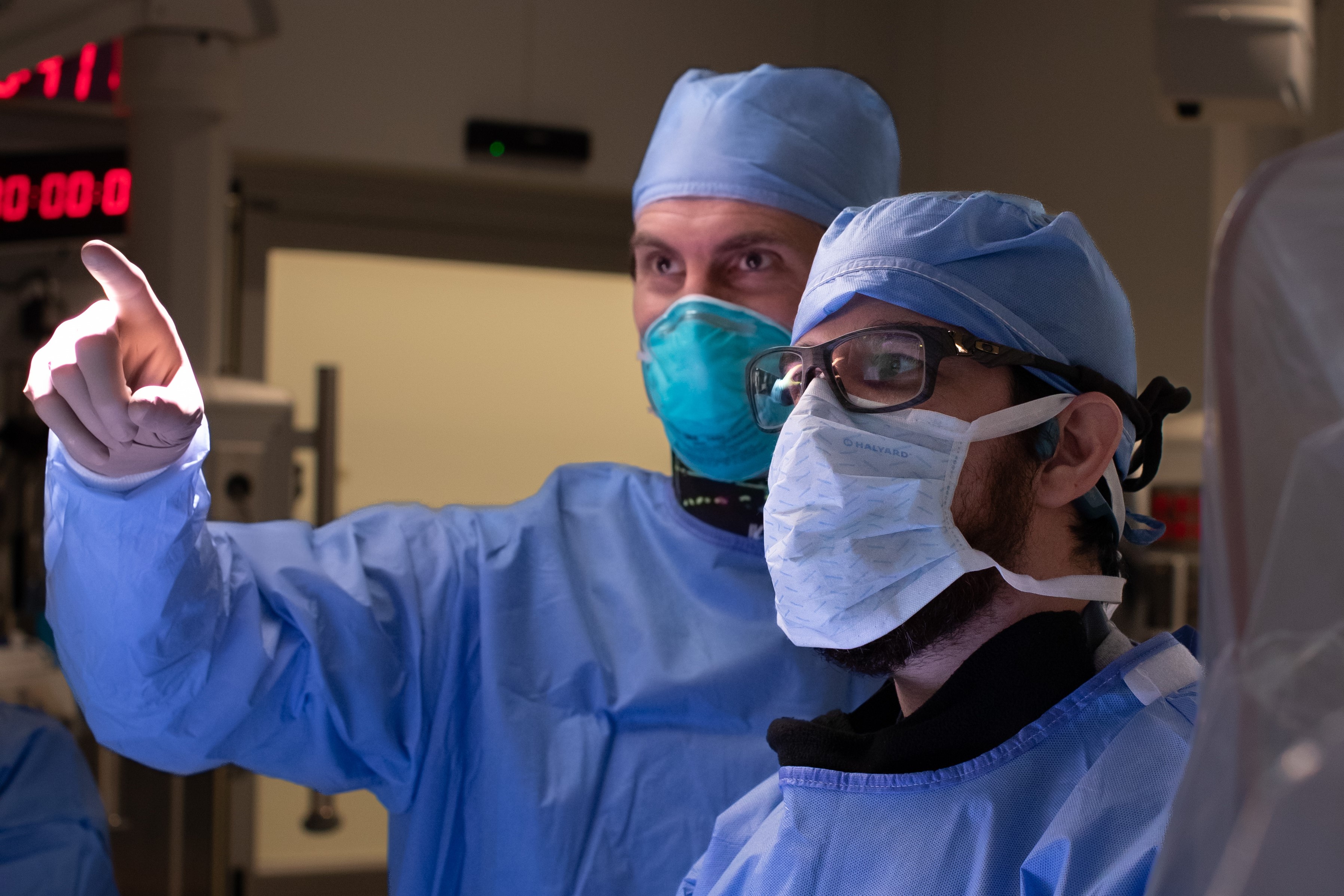 Dr. Jan-Karl Burkhardt assisting a fellow in the operating room.
