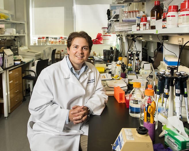 Dr. Kacy Cullen posing for a photo in his research lab.