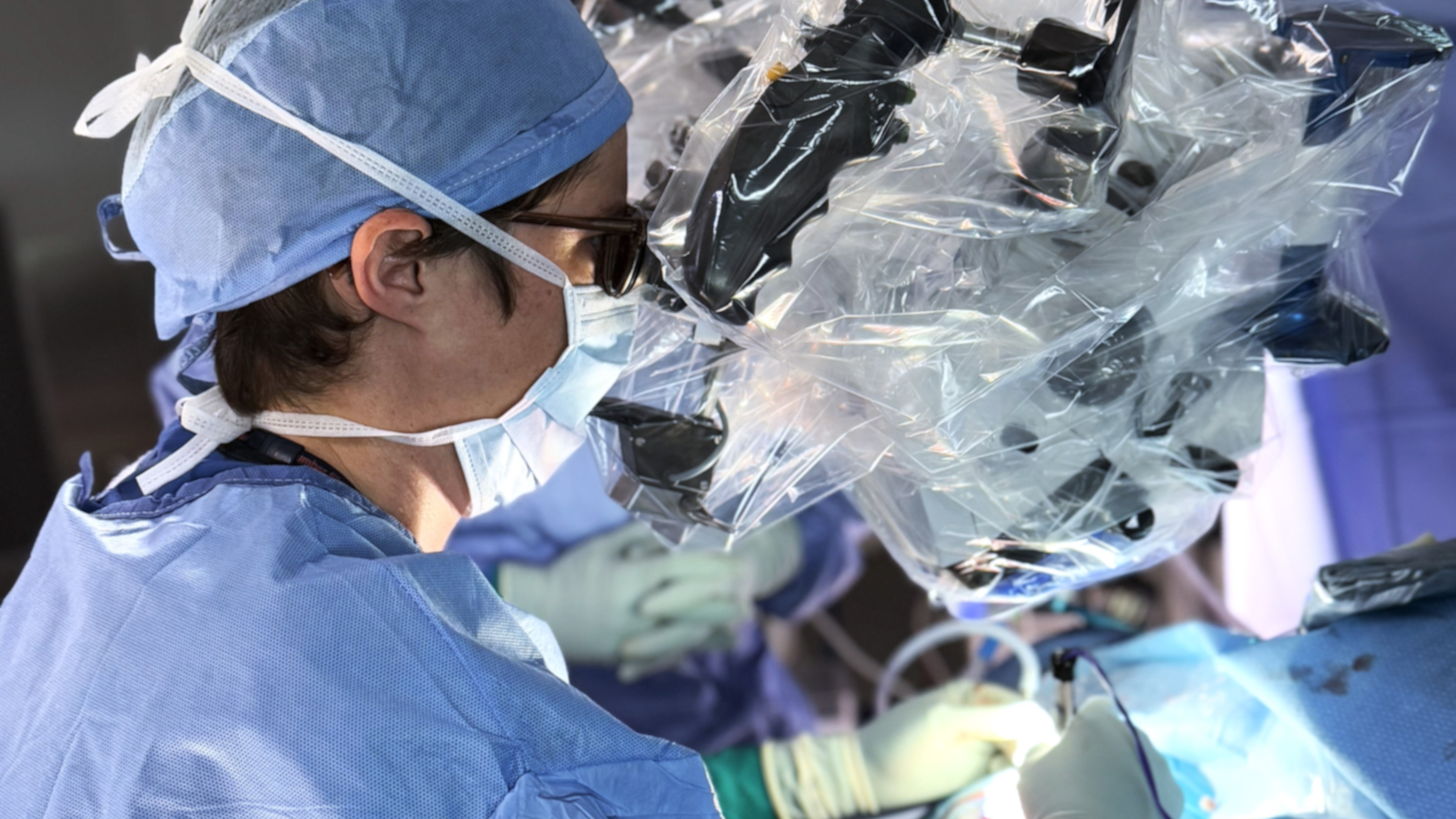 Chief resident looking through a scope during surgery.