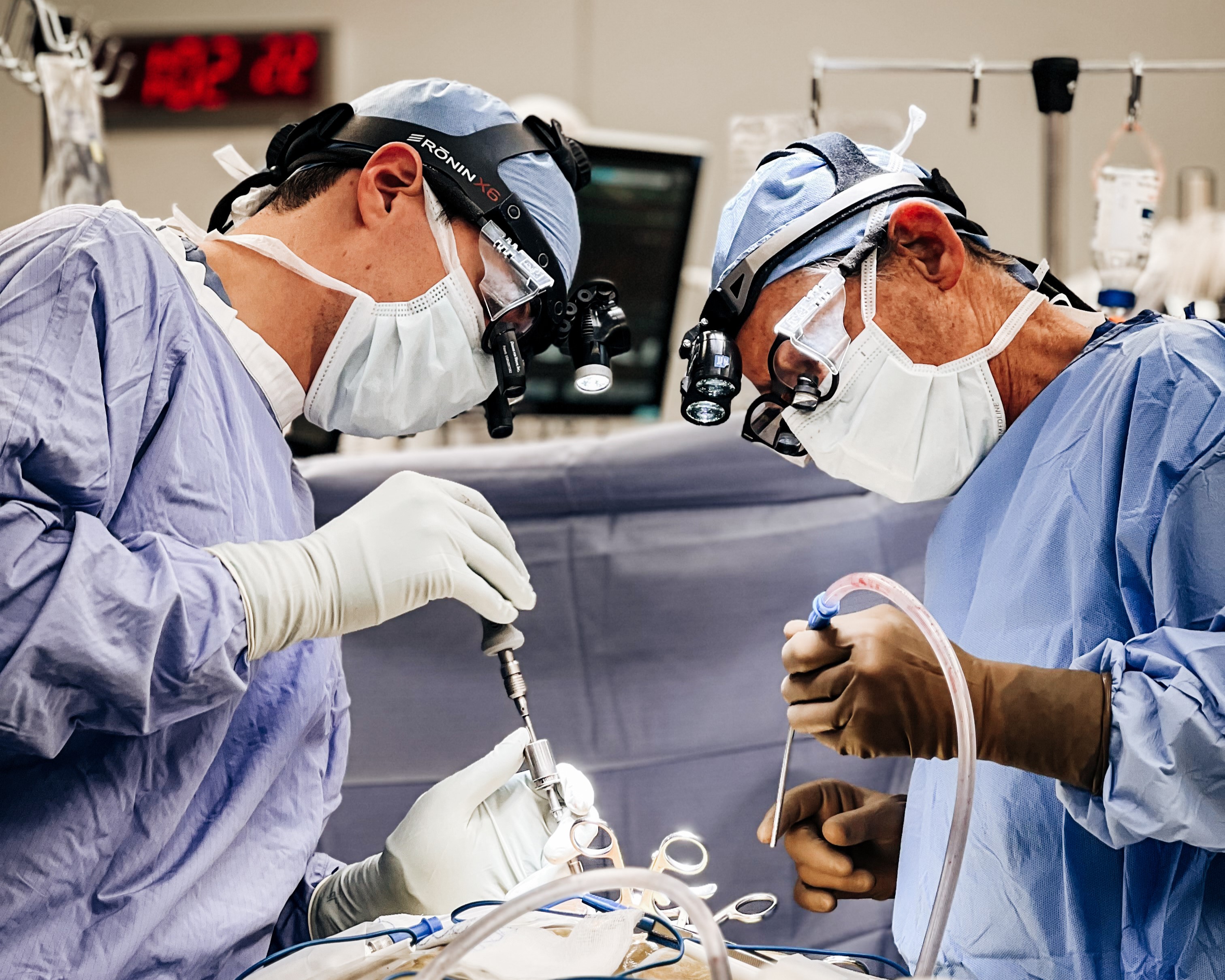 Dr. Eric Zager and a resident operating on a nerve case.