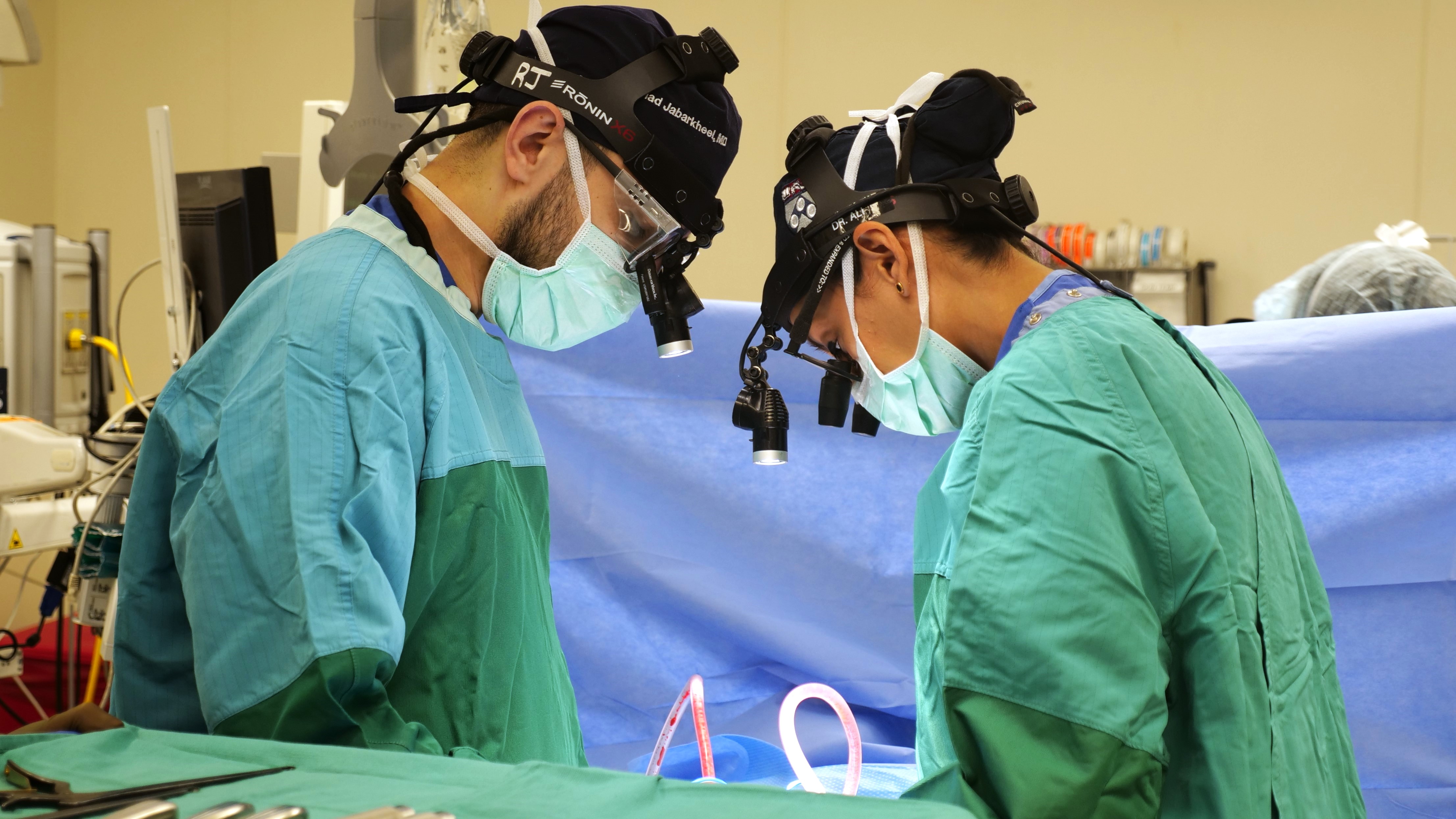 Zarina Ali performing surgery with help from a neurosurgery resident.