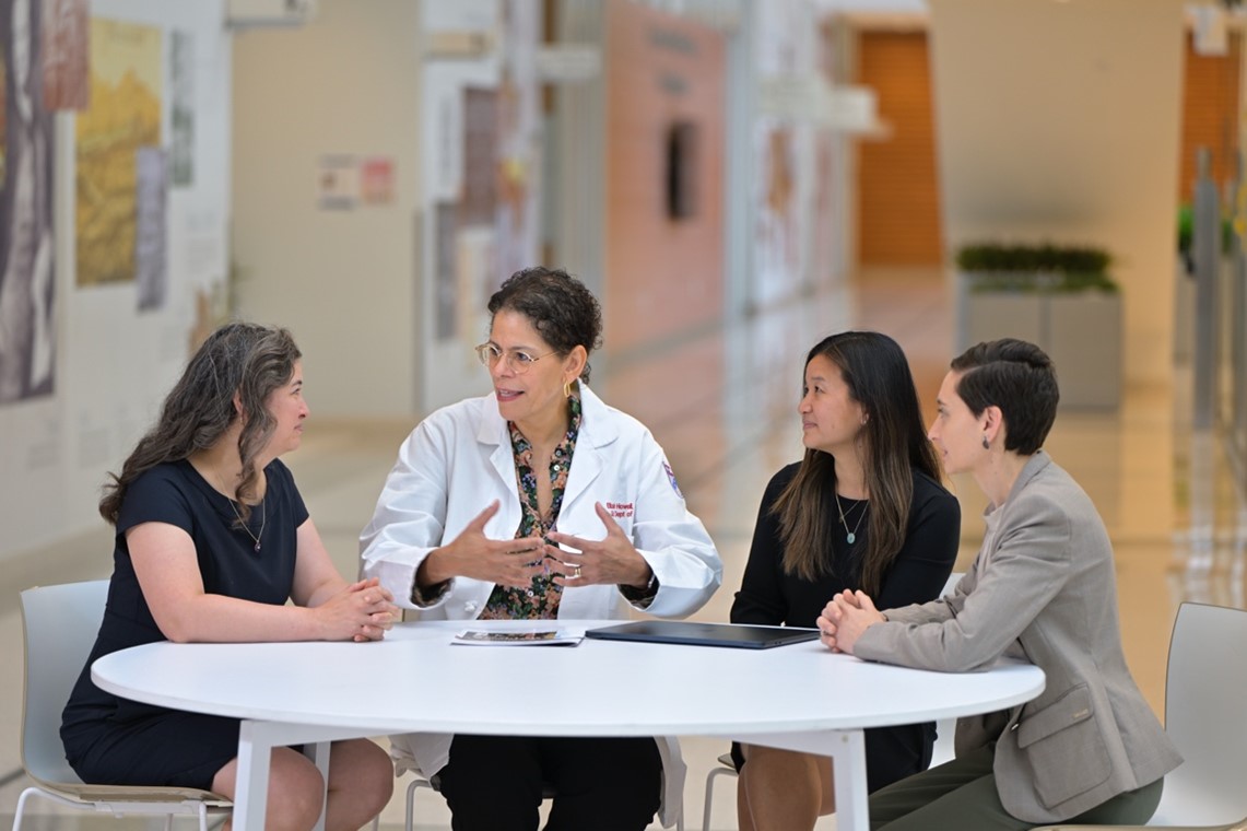 Dr. Howell sitting with colleagues