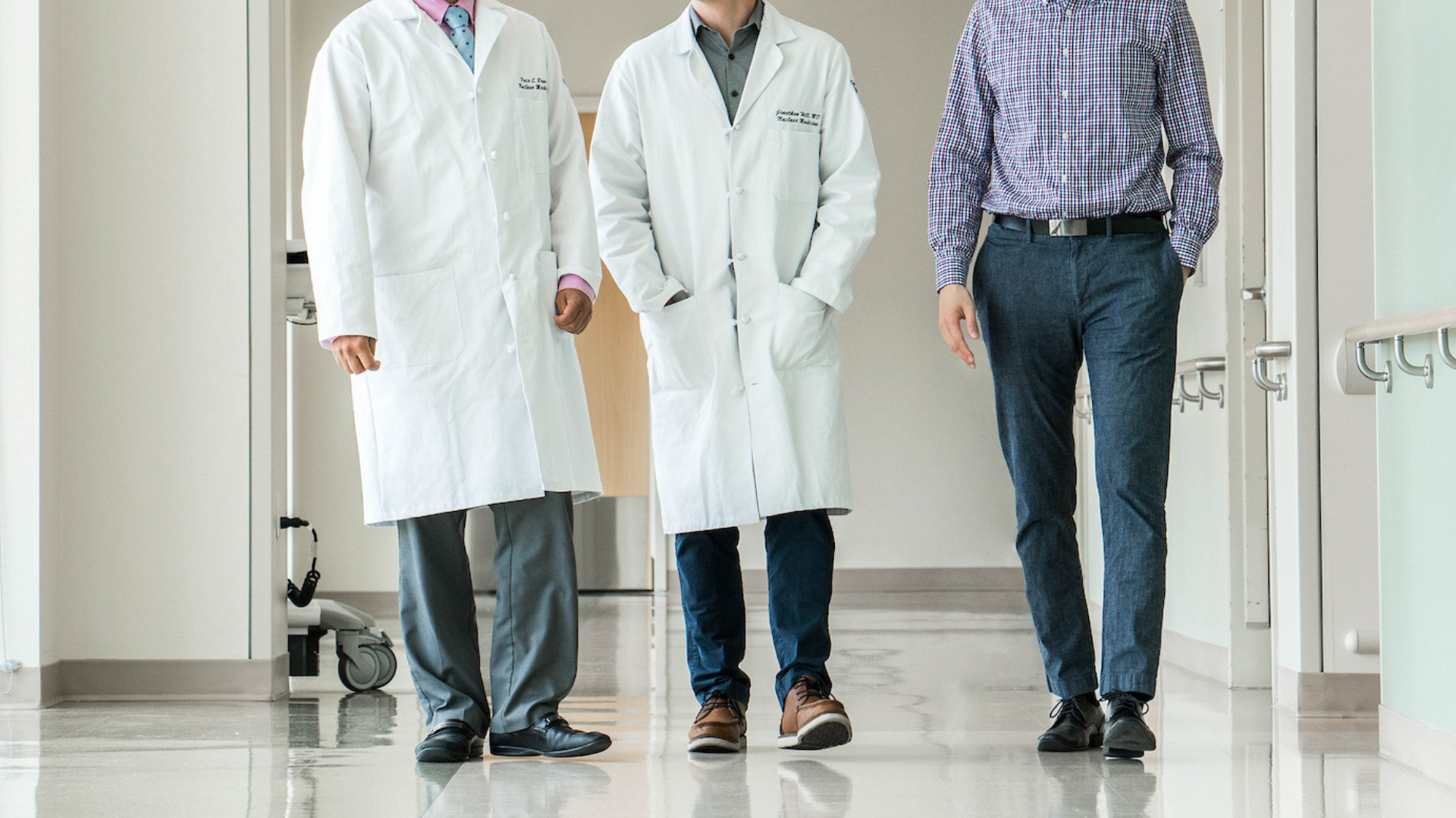 Photo of faculty members waling down a hallway