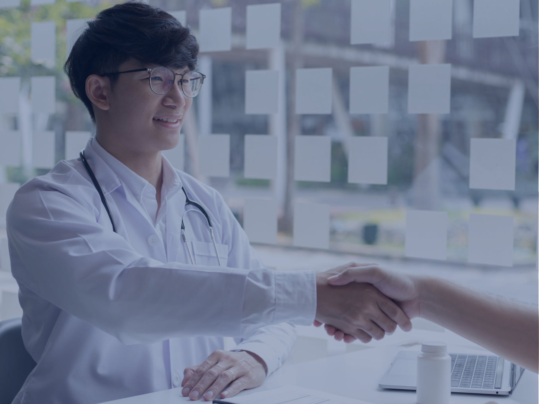 Person in whitecoat shaking hands