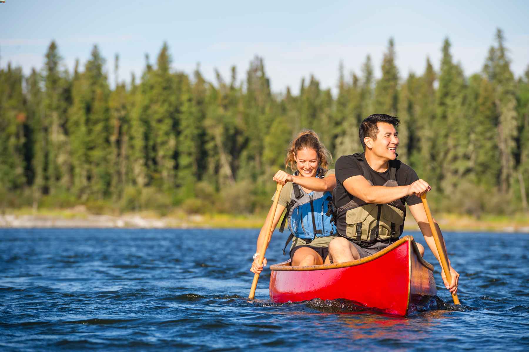 Couple canoeing on a lake at Lac LaRonge Provincial Park in Saskatchewan