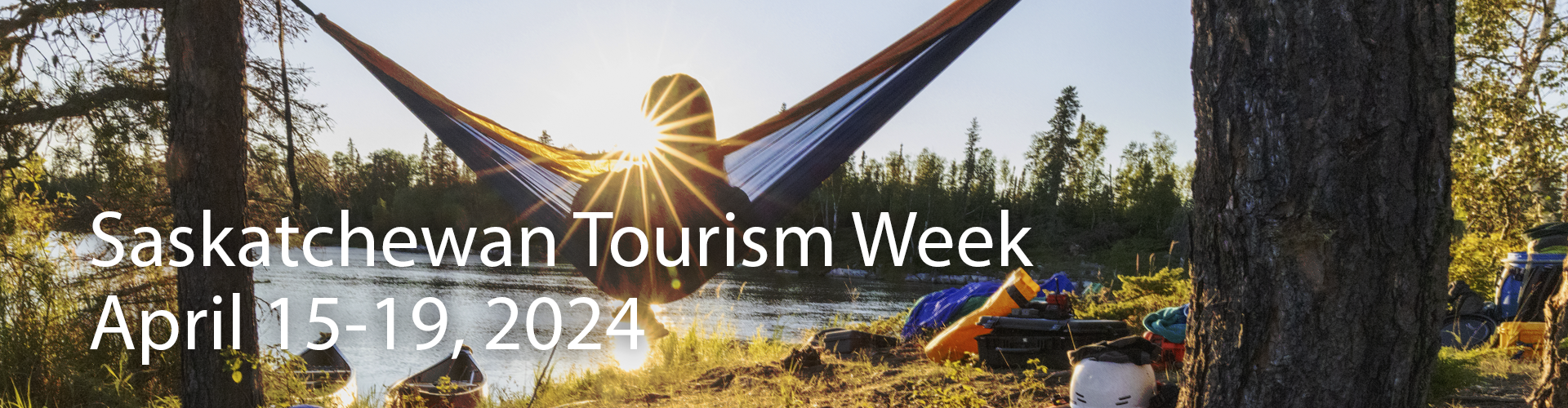 A person in a hammock with a lake in the background. The copy reads "Saskatchewan Tourism Week, April 15-19, 2024."