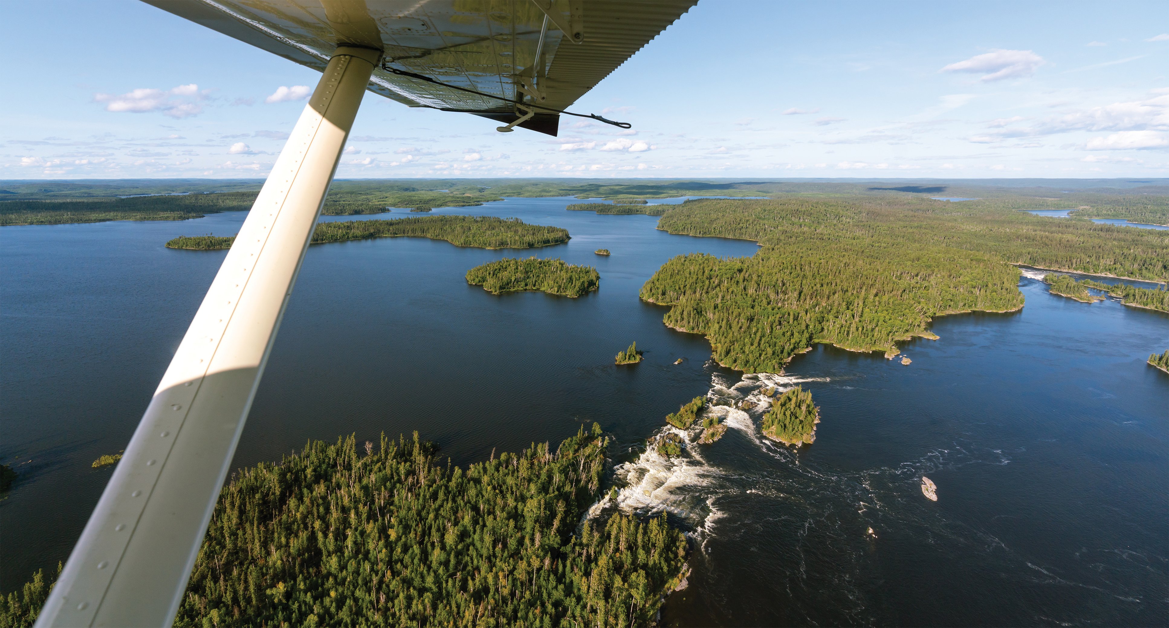 Aerial view of a lake and forest in northern Saskatchewan.