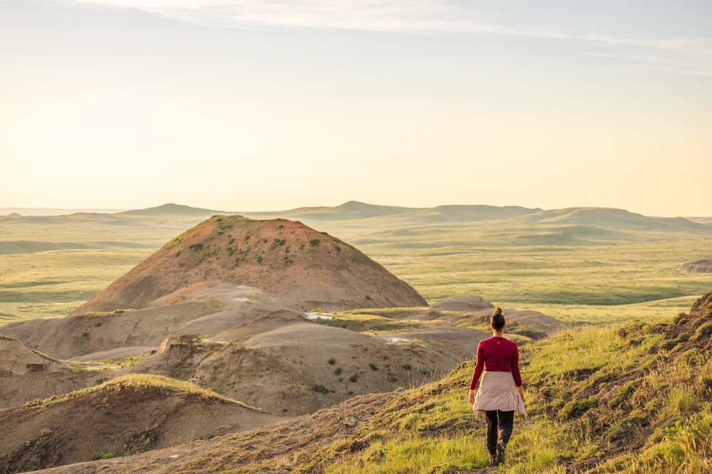 Person walking in the hills of Valley of 1,000 Devils in Grasslands National Park East Block