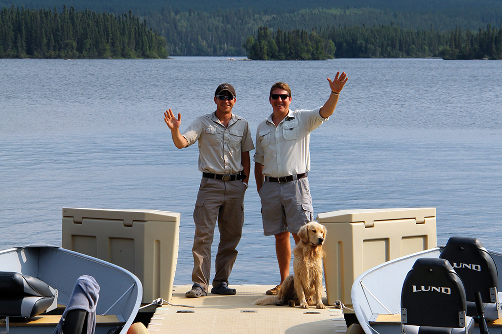 brothers standing on dock in northern saskatchewan